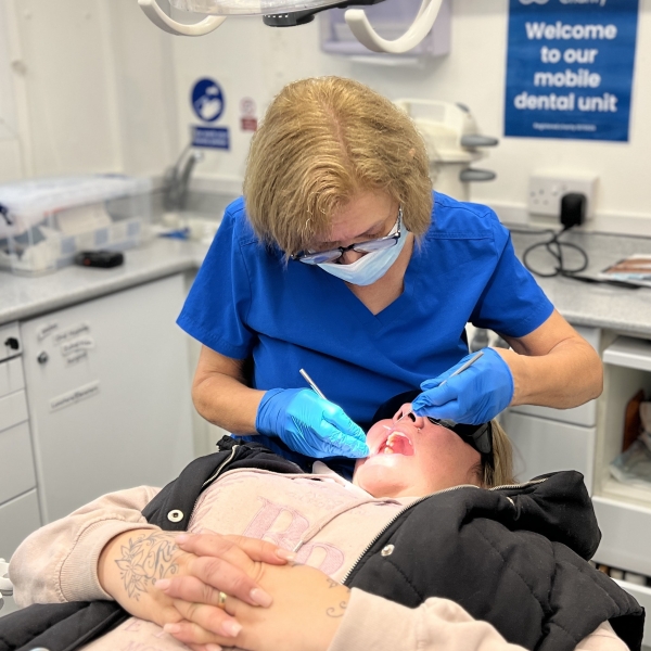 Dentist Mary Green treating a patient on the mobile dental unit.jpg